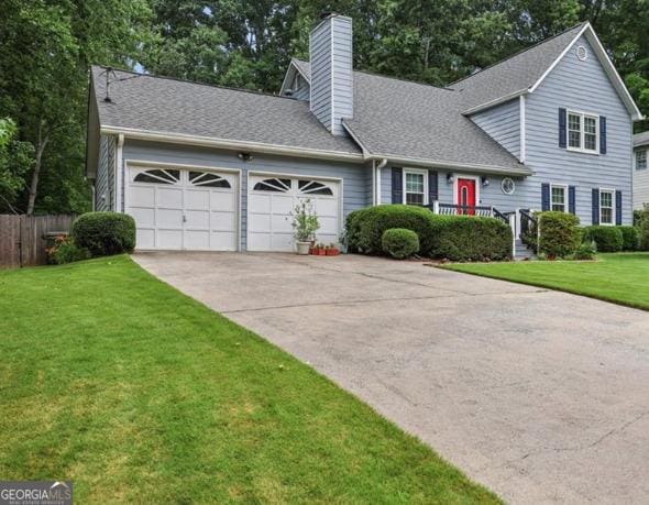 view of front facade with a garage and a front lawn