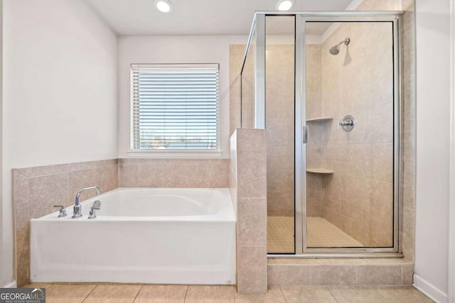 bathroom featuring a stall shower, tile patterned flooring, a bath, and recessed lighting