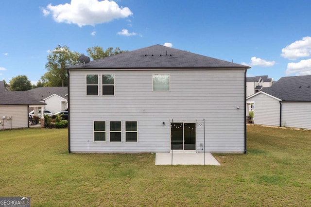 back of house with a patio and a yard