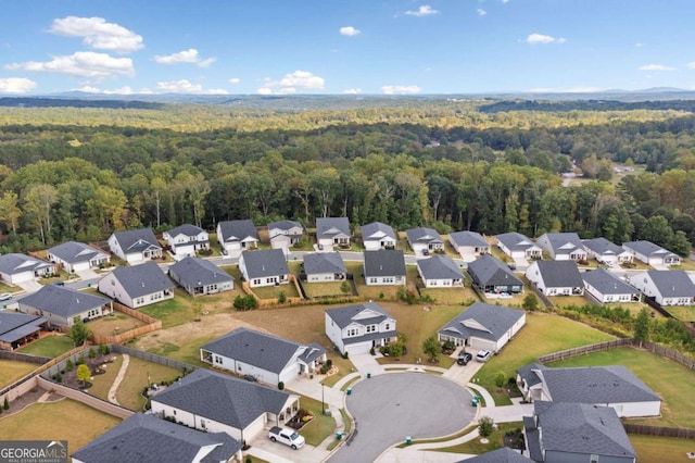 birds eye view of property with a residential view and a wooded view