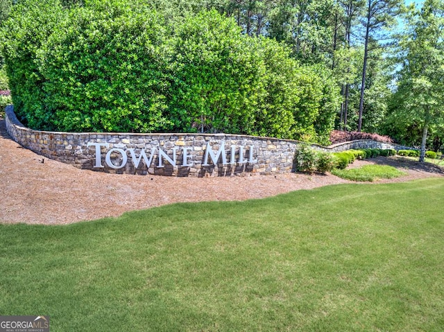 community / neighborhood sign with a lawn