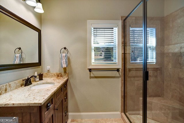 bathroom featuring walk in shower and vanity