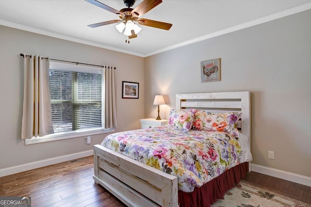 bedroom with wood-type flooring, ornamental molding, and ceiling fan