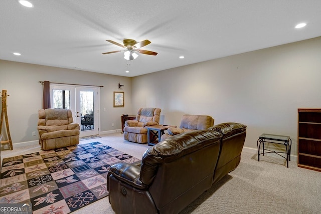 living room featuring french doors, ceiling fan, light carpet, and a textured ceiling