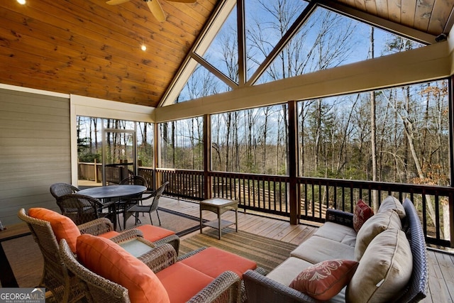 sunroom / solarium with ceiling fan, lofted ceiling, and wooden ceiling