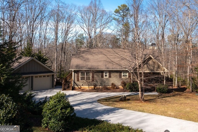 view of front of property featuring a garage and a front lawn