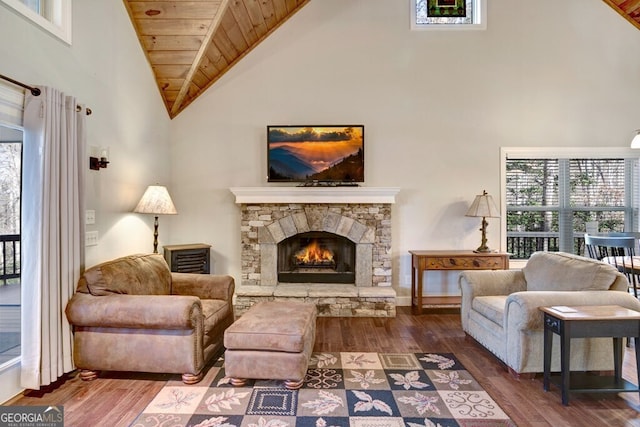 sitting room featuring hardwood / wood-style floors, wooden ceiling, high vaulted ceiling, and a fireplace