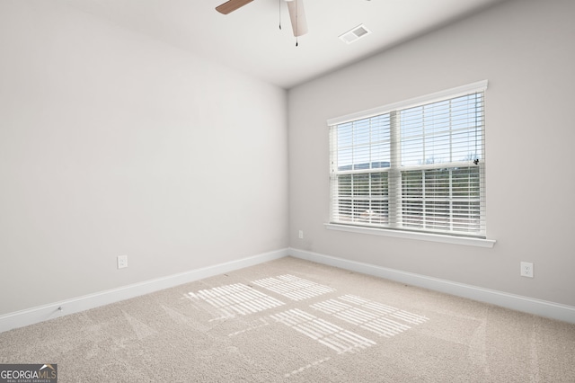 unfurnished room featuring visible vents, light carpet, and baseboards