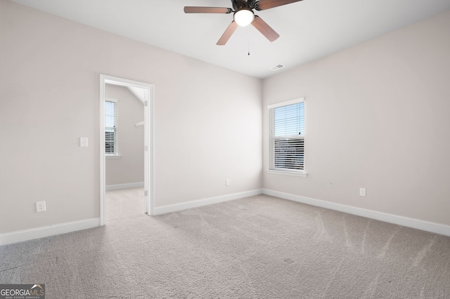 unfurnished room featuring a ceiling fan, baseboards, visible vents, and carpet flooring