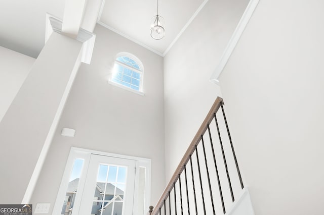 stairs featuring high vaulted ceiling and ornamental molding