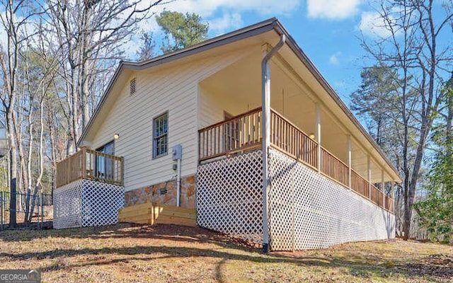 view of side of home with a balcony