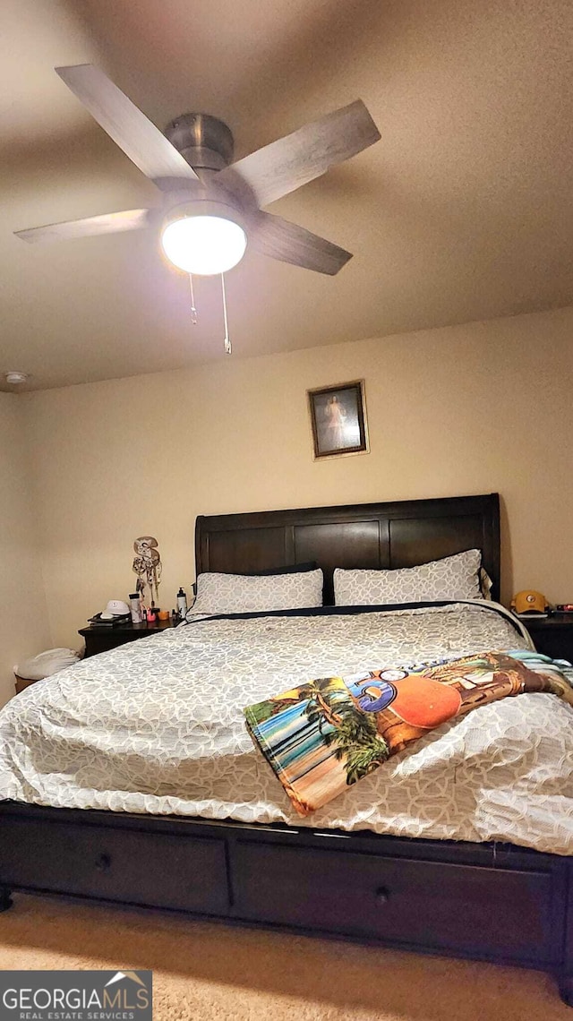 carpeted bedroom featuring ceiling fan