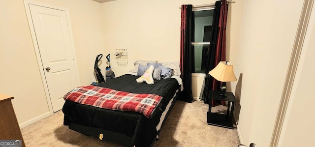 bedroom featuring light colored carpet