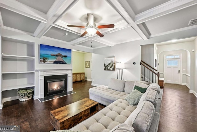 living room with beamed ceiling, coffered ceiling, and dark hardwood / wood-style flooring