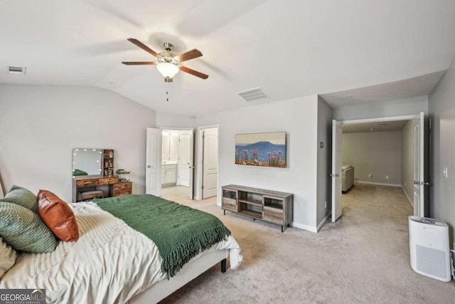 carpeted bedroom featuring lofted ceiling, connected bathroom, and ceiling fan