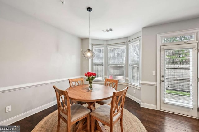 dining area with dark hardwood / wood-style floors and a wealth of natural light