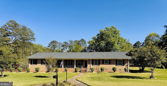 single story home featuring brick siding and a front lawn