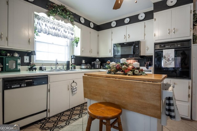 kitchen with light tile patterned flooring, sink, black appliances, ceiling fan, and white cabinets