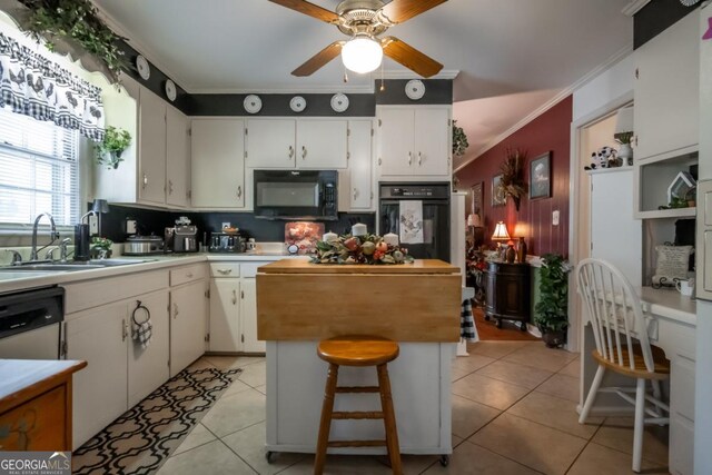 kitchen with ceiling fan, light tile patterned floors, ornamental molding, black appliances, and a sink