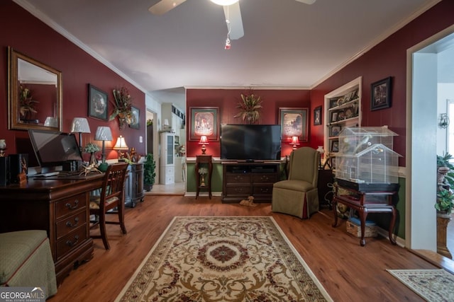 living room with wood finished floors, ornamental molding, and a ceiling fan