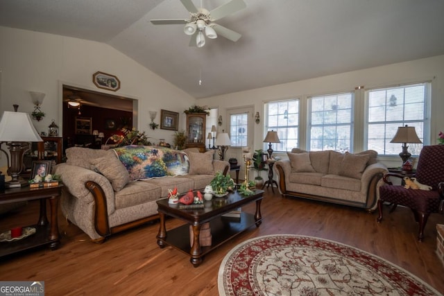 living room with ceiling fan, vaulted ceiling, and wood-type flooring