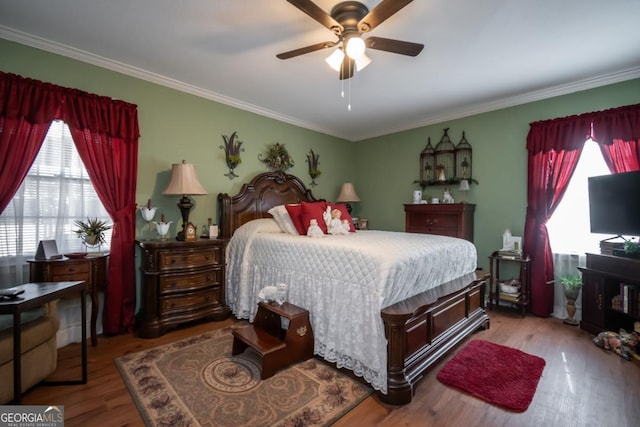 bedroom with crown molding, ceiling fan, and light hardwood / wood-style flooring