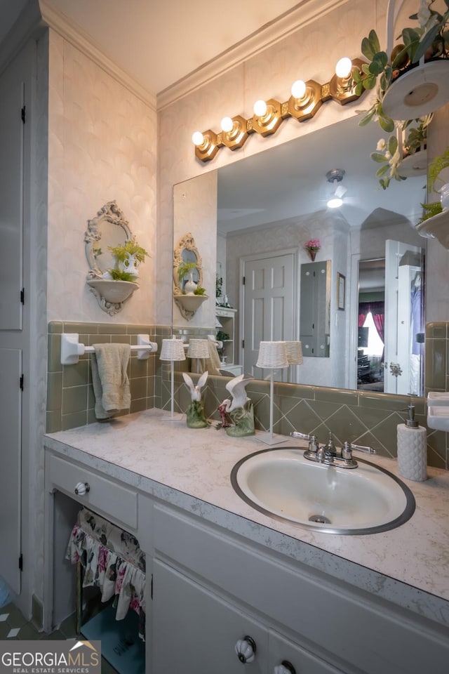 bathroom with vanity, ornamental molding, and decorative backsplash