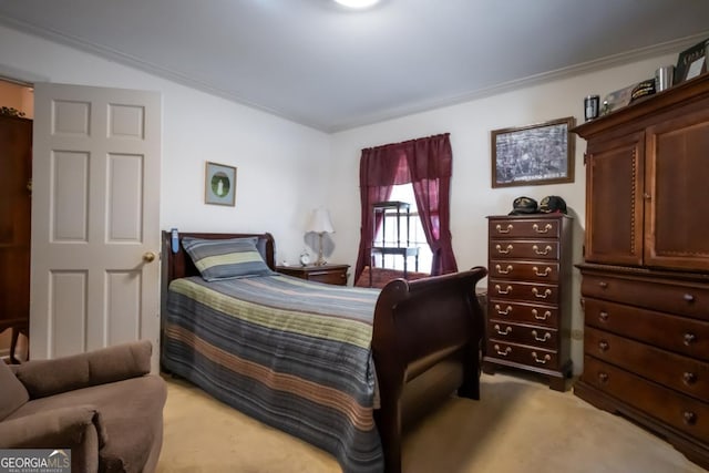 carpeted bedroom with ornamental molding