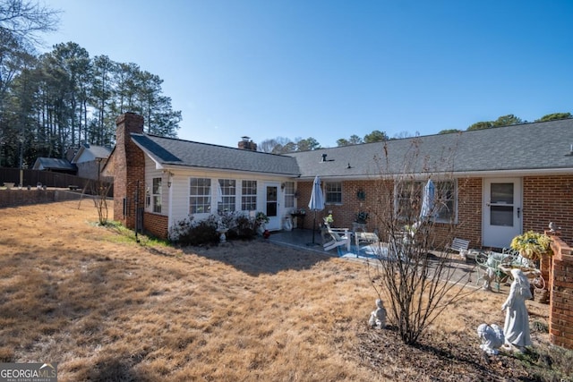 back of house featuring a yard and a patio area