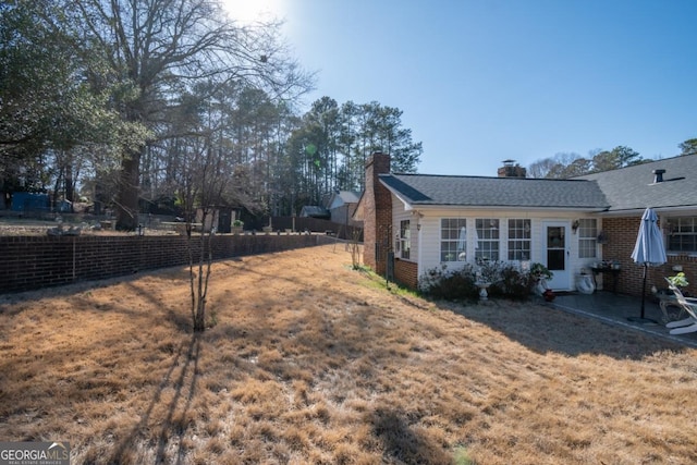 view of side of home featuring a lawn