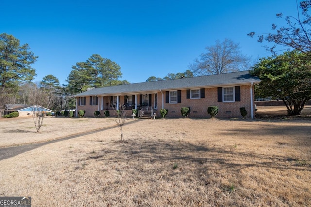 ranch-style house with covered porch and a front yard