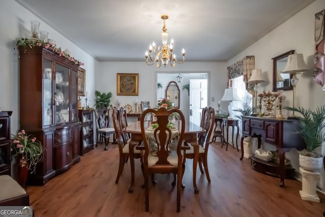 dining space featuring light wood-style flooring, crown molding, and an inviting chandelier