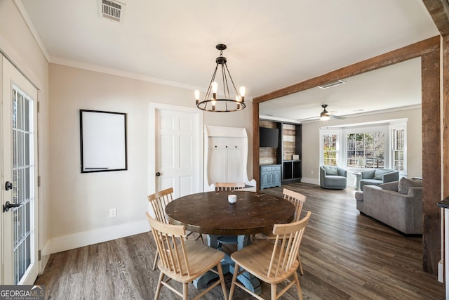 dining space featuring ceiling fan with notable chandelier, ornamental molding, and dark wood-type flooring