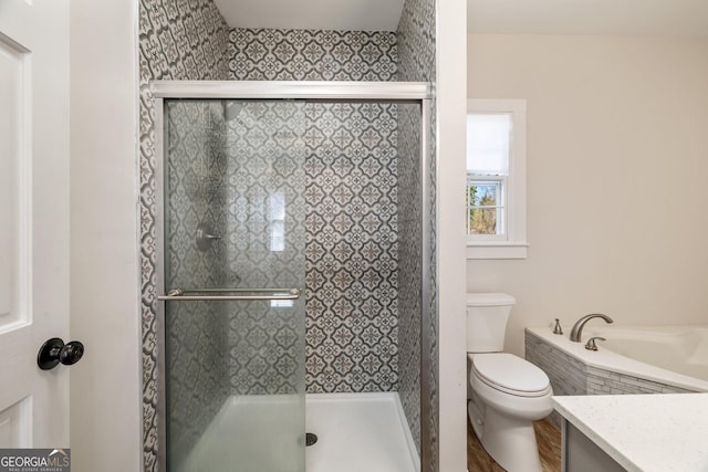 full bathroom featuring separate shower and tub, vanity, and toilet