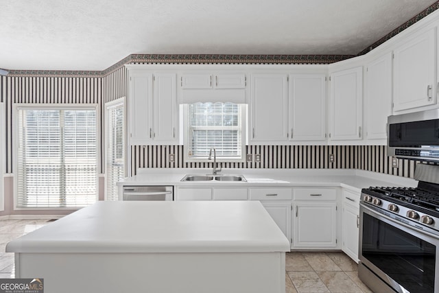 kitchen with white cabinetry, a healthy amount of sunlight, stainless steel appliances, and sink