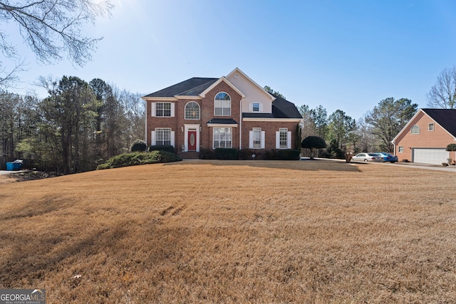 view of front of property featuring a garage and a front lawn