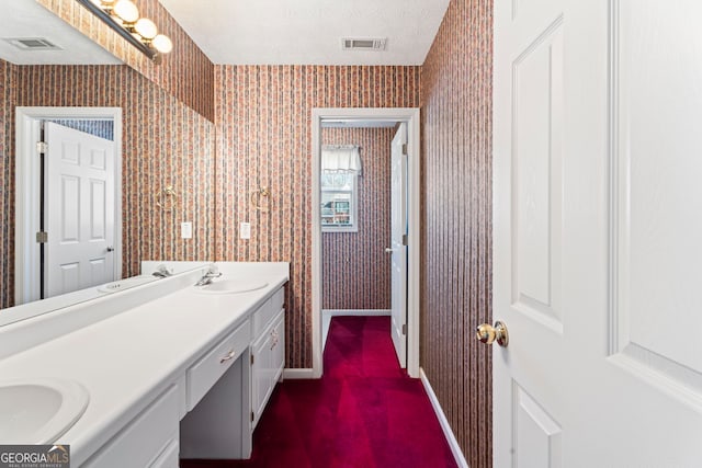 123 Stratmore Pl, Stockbridge, GA 30281 - bathroom with double vanity, wallpapered walls, and a textured ceiling