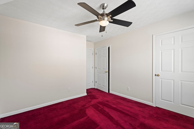 unfurnished bedroom featuring ceiling fan, carpet flooring, and a textured ceiling