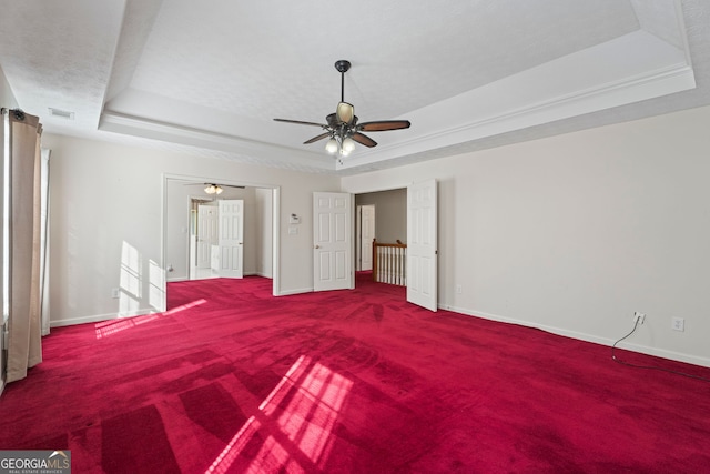 123 Stratmore Pl, Stockbridge, GA 30281 - unfurnished bedroom featuring a raised ceiling, carpet floors, and ceiling fan
