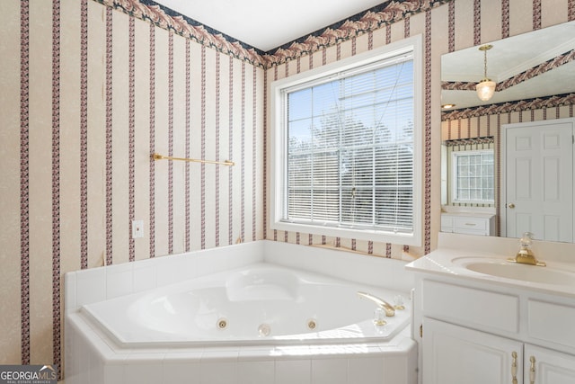 bathroom with vanity and a relaxing tiled tub
