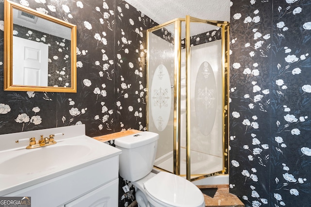 bathroom featuring vanity, toilet, and an enclosed shower