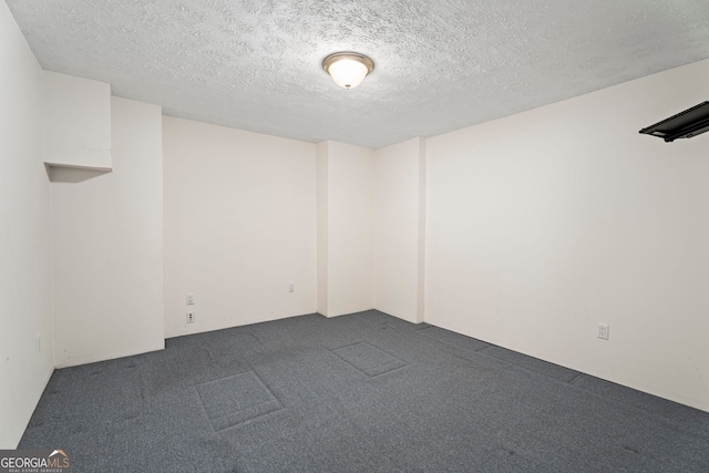 123 Stratmore Pl, Stockbridge, GA 30281 - spare room featuring dark carpet and a textured ceiling