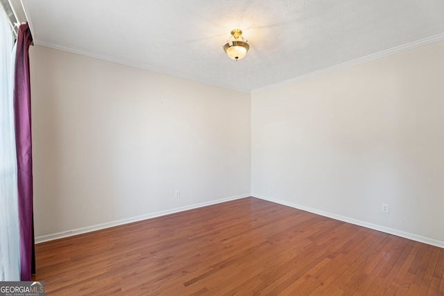unfurnished room with crown molding and hardwood / wood-style floors