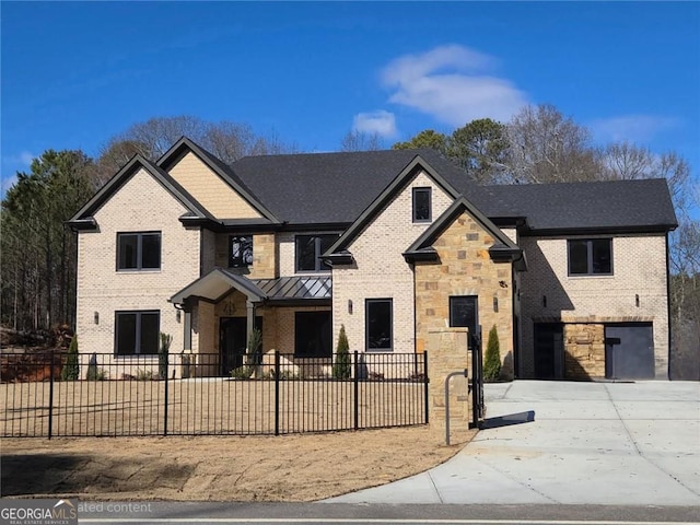 view of front of home with driveway, stone siding, a standing seam roof, and brick siding