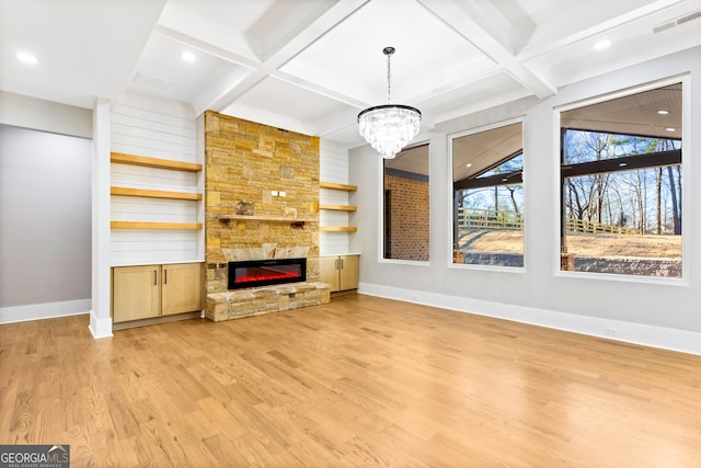 unfurnished living room featuring visible vents, a fireplace, light wood-style flooring, and baseboards