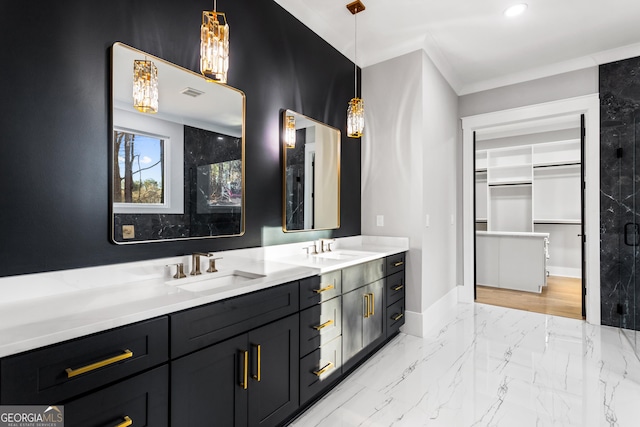 bathroom with double vanity, visible vents, marble finish floor, a spacious closet, and a sink