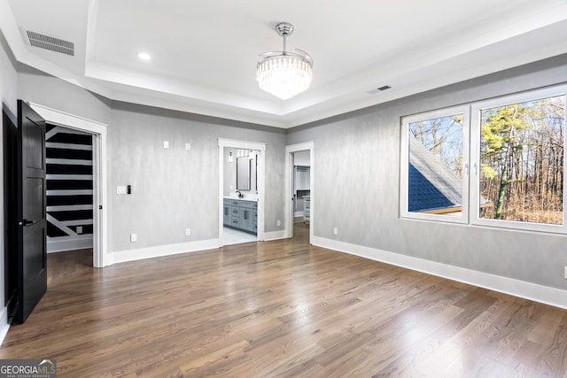 interior space featuring a spacious closet, visible vents, and wood finished floors