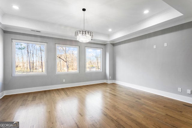 unfurnished dining area with baseboards, a chandelier, wood finished floors, and recessed lighting