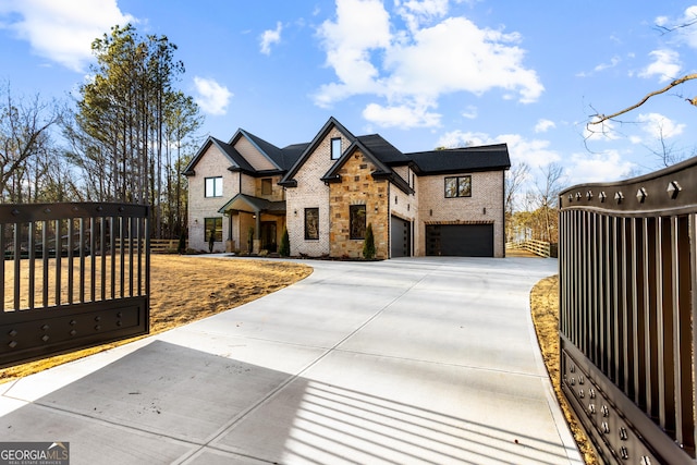 view of front of house featuring driveway, an attached garage, a gate, and fence