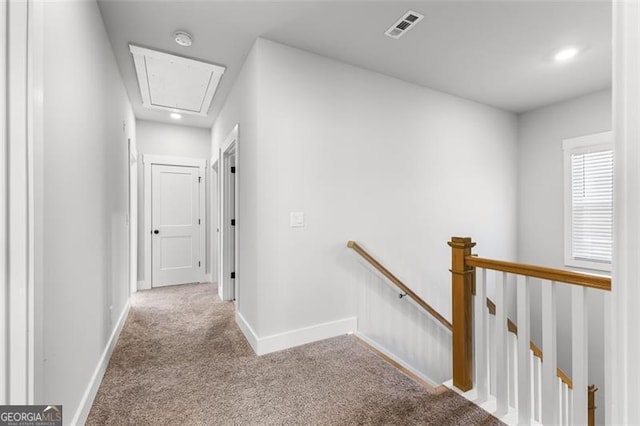 hall featuring light colored carpet